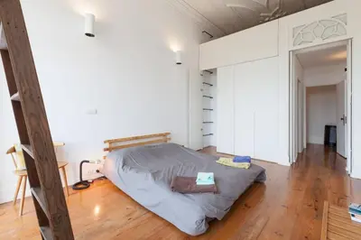 a bedroom with a bed in the middle of a room at Alegria 1º in Porto