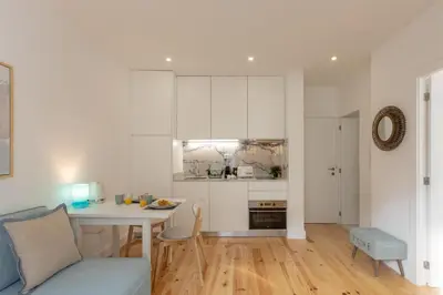 a kitchen and living room with a table and a couch at Sweet Flat 4Two in City Center, Balcony & Air Conditioning in Porto