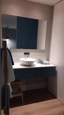 a bathroom counter with a sink and a mirror at Invicta Oporto Residence in Porto