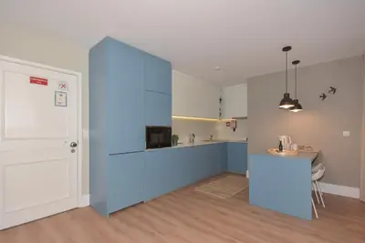 a kitchen with a blue island in a room at Invicta Oporto Residence in Porto