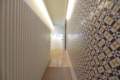 a hallway with a wall of mosaic tiles on it at FLH Porto Spacious Duplex in Porto