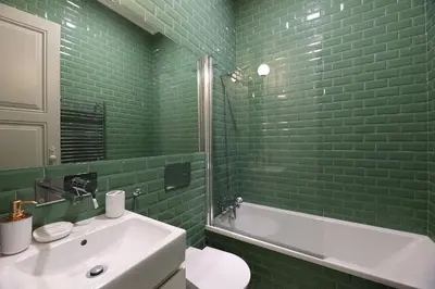 a green tiled bathroom with a sink and a tub at FLH Porto Trendy Flat in Porto