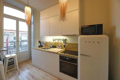 a kitchen with a refrigerator and a microwave at FLH Porto Trendy Flat in Porto