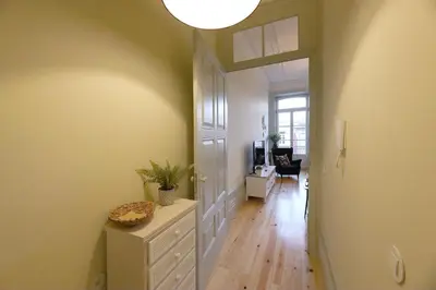a hallway with a room with a door and a table at FLH Porto Trendy Flat in Porto