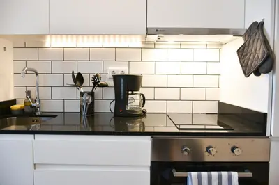 a kitchen counter with a coffee maker on it at Comfortable&Central w/balcony-9 min walk Trindade in Porto
