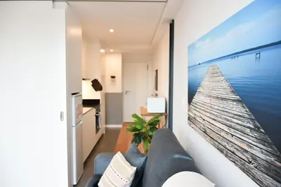 a living room with a large picture of the ocean at Comfortable&Central w/balcony-9 min walk Trindade in Porto