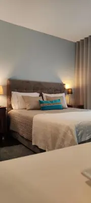 a bedroom with a large bed with pillows on it at Suite Camões in Porto