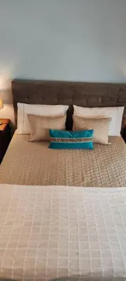 a bedroom with a bed with pillows on it at Suite Camões in Porto