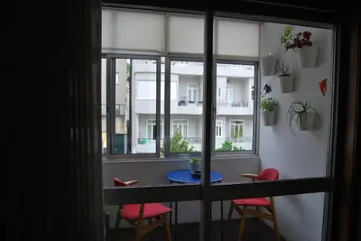 a room with a table and chairs and a window at Suite Camões in Porto