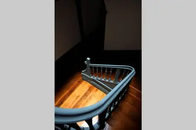 a blue bench sitting on top of a wooden floor at São Miminho 3º in Porto