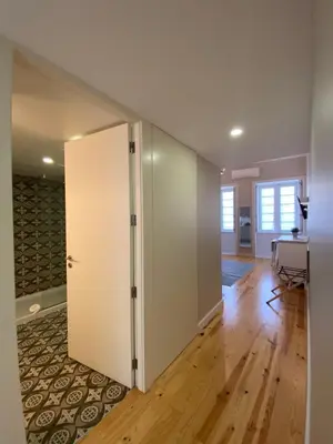an open door in a room with wood floors at Vitoria's Terrace Apartments in Porto