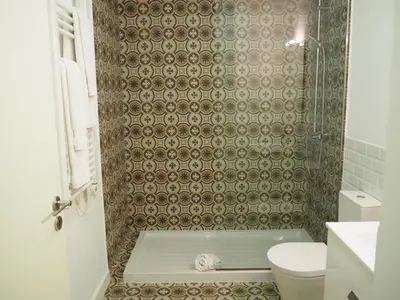 a bathroom with a shower with a toilet at Vitoria's Terrace Apartments in Porto