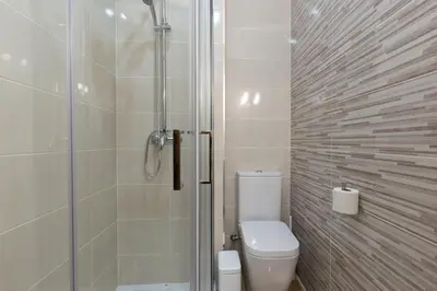 a bathroom with a toilet and a glass shower at Yellow Tiles by PCALE in Porto