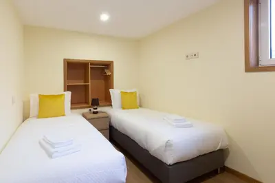 two beds sitting next to each other in a room at Yellow Tiles by PCALE in Porto