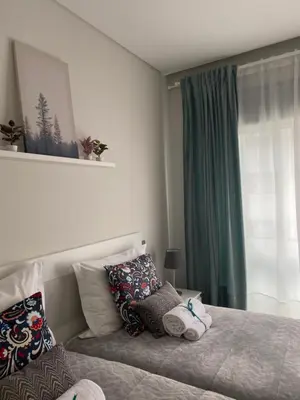 a bedroom with a bed with pillows and a window at A&R Bolhão Apartment in Porto
