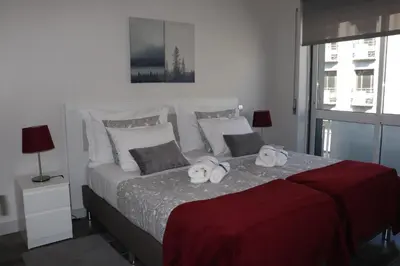 a bedroom with a bed with two towels on it at A&R Bolhão Apartment in Porto