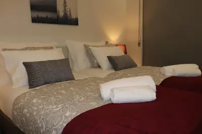 a bedroom with two beds with white pillows at A&R Bolhão Apartment in Porto