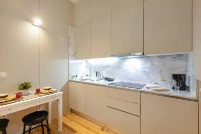 a room with a bed and a living room at Sol Modern Studio @ Batalha in Porto