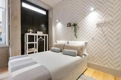 a living room with white furniture and a television at Sol Modern Studio @ Batalha in Porto