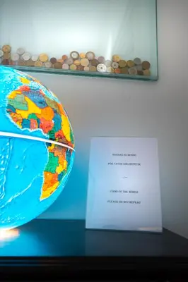 a map of the earth next to a sign at Alegria Cozy com Terraço - Centro do Porto in Porto