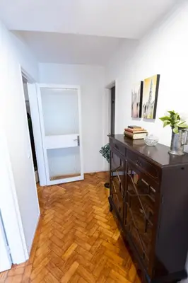 a living room with a wooden floor and a dresser at Alegria Cozy com Terraço - Centro do Porto in Porto