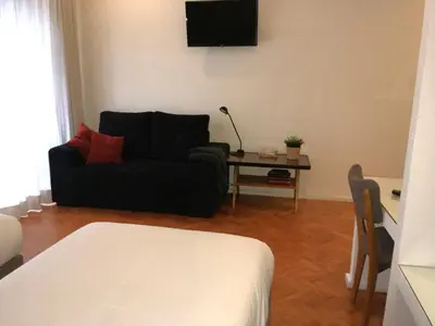 a living room with a couch and a table at Alegria Cozy com Terraço - Centro do Porto in Porto