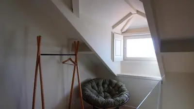 a small room with a chair under a window at Oporto Maison Palace in Porto