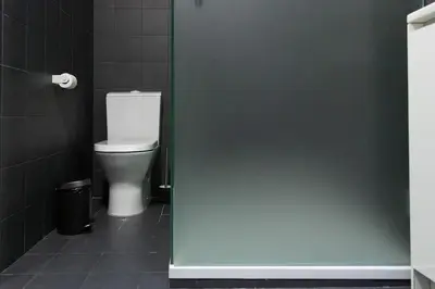 a bathroom with a white toilet in a stall at Batalha Mezzanine Penthouse in Porto