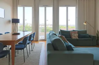 a person laying on a couch in a living room at Batalha Mezzanine Penthouse in Porto