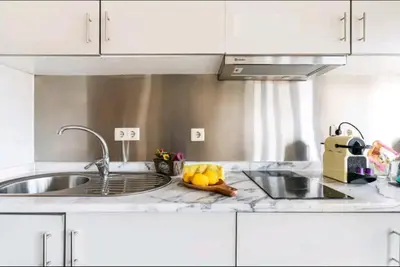 a kitchen with a sink and a counter top at Invictus Porto Apartment in Porto