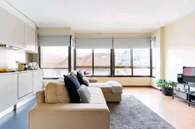 a living room with a couch and a kitchen at Invictus Porto Apartment in Porto