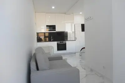 a living room with a couch and a kitchen at VB Porto City Studio, by Flat in Porto in Porto