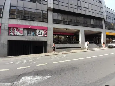 two people walking down a street in front of a building at VB Porto City Studio, by Flat in Porto in Porto