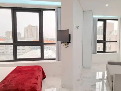 a white room with a bed and a tv at VB Porto City Studio, by Flat in Porto in Porto
