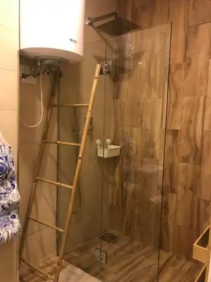 a shower with a glass door and a lamp at City Heart Place 4 in Porto