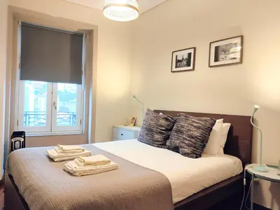 a bedroom with a bed with towels on it at Porto Main Square Penthouse Apartment in Porto