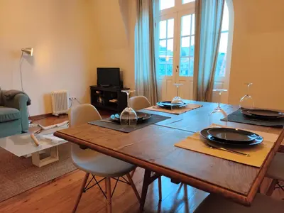 a dining room with a wooden table and chairs at Porto Main Square Penthouse Apartment in Porto