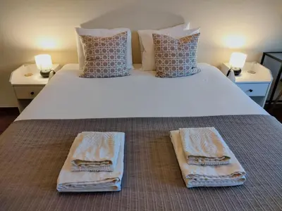 a bedroom with a large bed with towels on it at Porto Main Square Penthouse Apartment in Porto