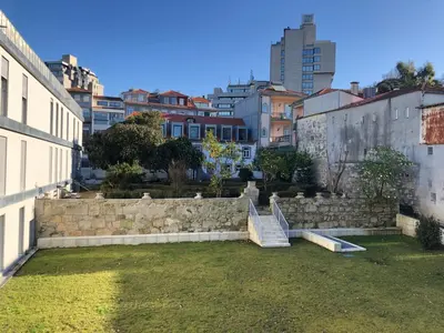 a stone retaining wall and stairs in a city at BBA Apartments Palácio I - Douro View, Gym & Free Parking in Porto