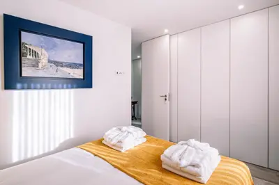 a bedroom with a bed with two towels on it at BBA Apartments Palácio I - Douro View, Gym & Free Parking in Porto