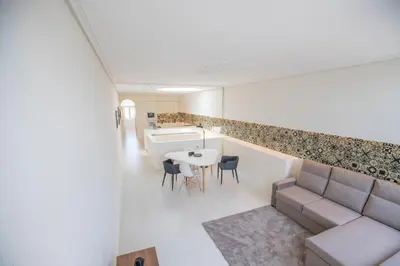 a living room with a couch and a table and a kitchen at GuestReady - Porto D'Alma - Stª Catarina 1E in Porto