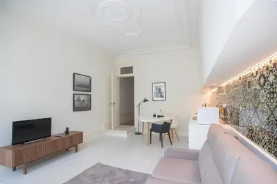 a white living room with a couch and a table at GuestReady - Porto D'Alma - Stª Catarina 1E in Porto