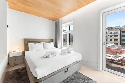 a bedroom with a bed and a large window at GuestReady - Porto D'Alma - Stª Catarina 1E in Porto