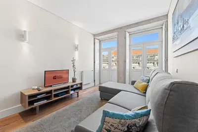 a living room with a couch and a television at GuestReady - Cardosas Town Apartment in Porto