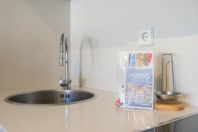 a kitchen counter with a sink and a bag of toothpaste at GuestReady - Cardosas Town Apartment in Porto
