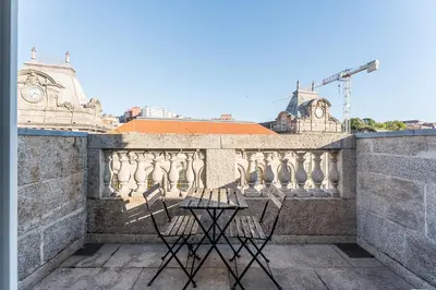 two chairs sitting on a ledge of a balcony at GuestReady - Cardosas Town Apartment in Porto