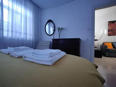 a bedroom with a bed with white towels on it at Casa da Rita in Porto