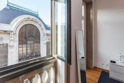 a room with a window with a view of a building at BO - Bolhão Apartments in Porto