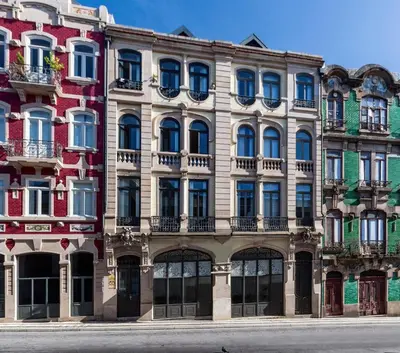 a large building with lots of windows on a street at BO - Bolhão Apartments in Porto
