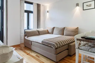 a living room with a couch in a room at BO - Bolhão Apartments in Porto